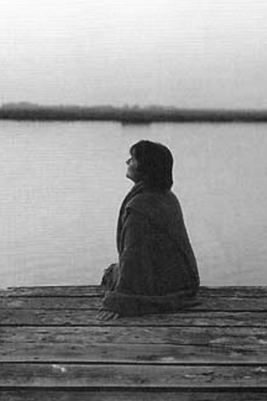 Rina Menardi sitting on dock at lake