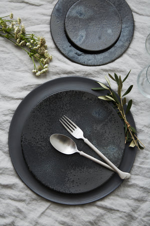 Charger plate in matte black by Rina Menardi